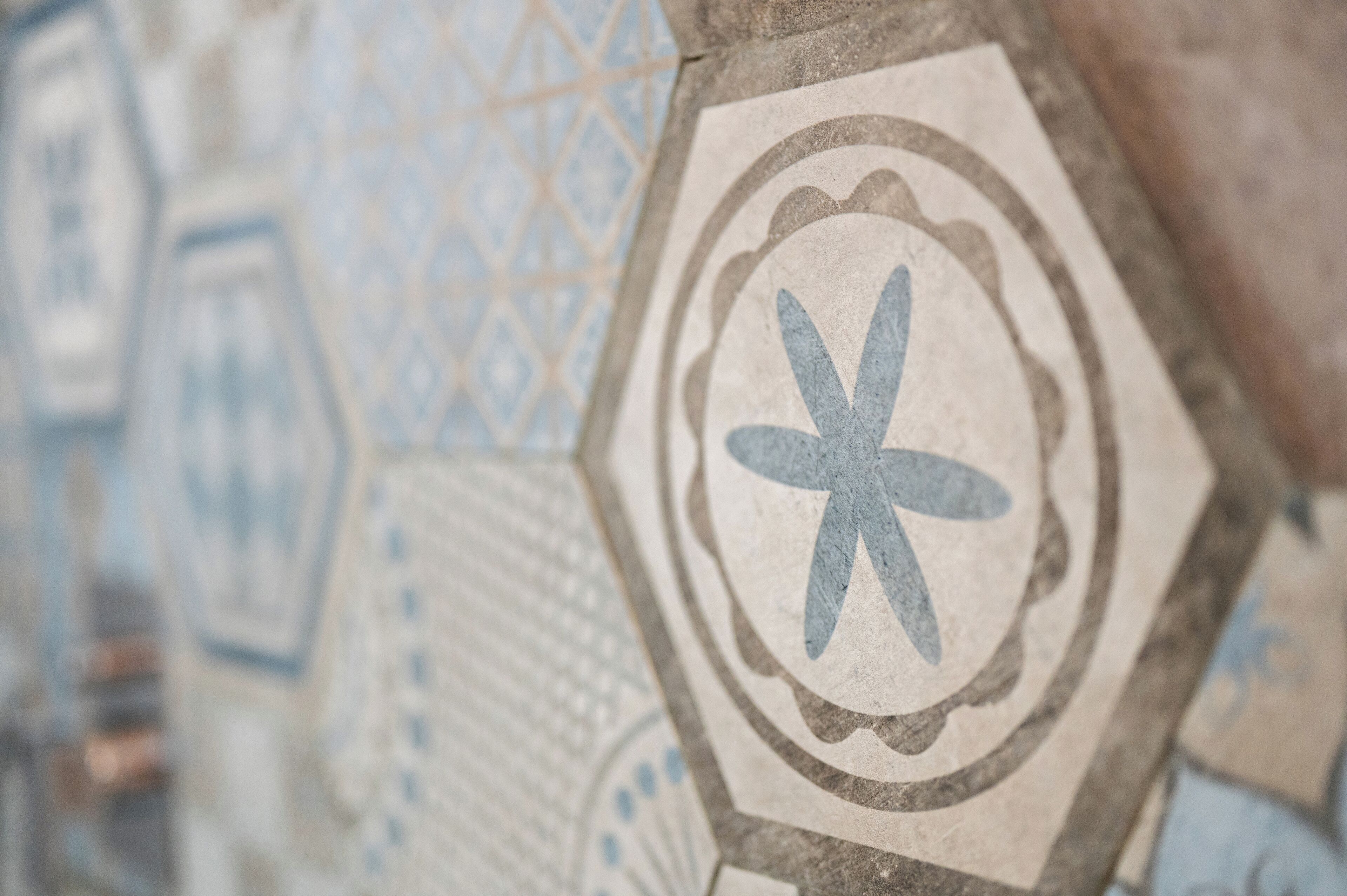 A close-up of a mosaic tile with a geometric pattern.
