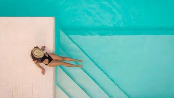 Seasonal outdoor pool, open 9:00 AM to 7:30 PM, pool loungers