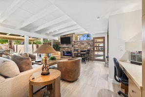 A spacious living area with a fireplace, comfortable seating, and a television. - El Paseo, 'The Rodeo Drive of Beverly Hills' In Palm Desert. Free Wi FI (Palm Desert)