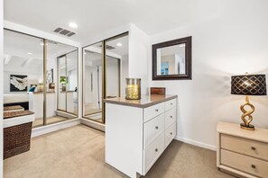 A modern bathroom with a vanity, mirror, and a decorative lamp. - El Paseo, 'The Rodeo Drive of Beverly Hills' In Palm Desert. Free  Wi FI (Palm Desert)