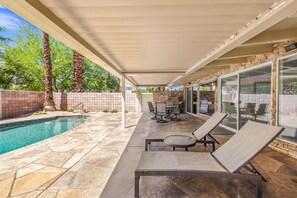 A covered patio with a pool, lounge chairs, and a barbecue area. - El Paseo, 'The Rodeo Drive of Beverly Hills' In Palm Desert. Free  Wi FI (Palm Desert)