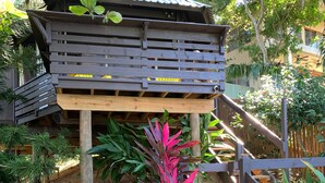 A wooden deck with a staircase leading up to a house.
