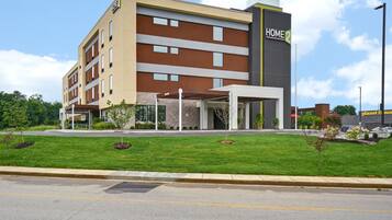 A multi-story hotel with a modern design, featuring a prominent "HOME 2" sign.