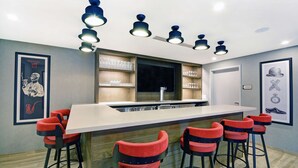 Eine moderne Küche mit Barbereich, ausgestattet mit einer langen Arbeitsplatte und mehreren Barhocker.