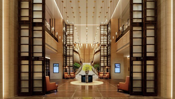 A spacious lobby with a central staircase, seating areas, and a large potted plant. - Hilton Chengdu Chenghua - Close to Panda Base and Chengdu East Railway Station (Chengdu)