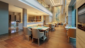A modern hotel lobby with a spacious seating area, a high ceiling with a unique spiral light fixture, and a view of the kitchen area. - Hilton Chengdu Chenghua - Close to Panda Base and Chengdu East Railway Station (Chengdu)