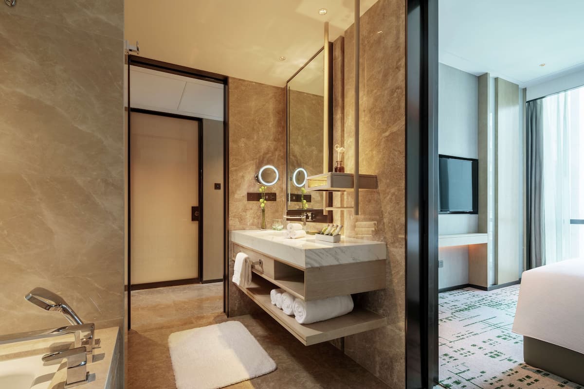 king 1 bedroom junior suite | bathroom | separate bathtub and shower, rainfall showerhead, designer toiletries
