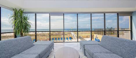 Relax in this inviting lounge with panoramic beach views and easy access to the pool and sunbathing area