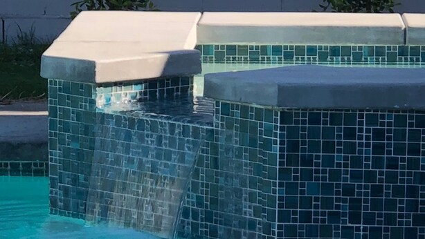 A swimming pool with a tiled waterfall feature and a white roof. - The Colony House Palm Springs (Palm Springs)