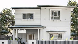 A two-story building with a sign reading "The BAXLEY BONDI Boutique Accommodation." - The Baxley Bondi (Bondi)