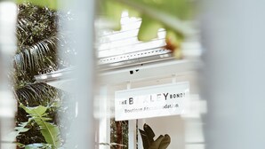 A modern boutique hotel entrance with a sign reading "The Baxter Bondi Boutique Accommodation." - The Baxley Bondi (Bondi)