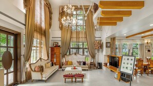A spacious living room with a sofa, ottomans, a coffee table, and a fireplace. - Pass Happiness On (Wujie)