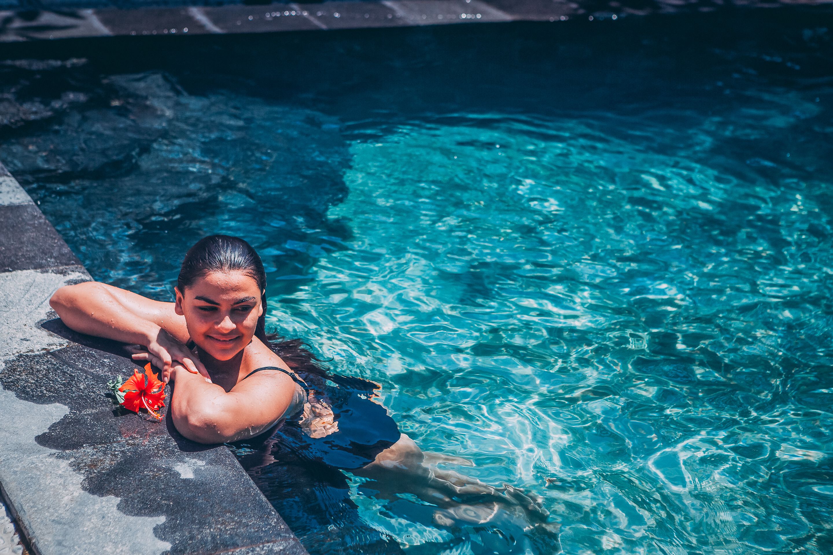 A person in a swimming pool with clear water.