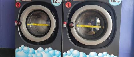 Dos lavadoras de carga frontal de 12 kg, con capacidad de 24 kg, a un precio de RM 7,00 y RM 8,00, y un tiempo de ciclo de 32 minutos.