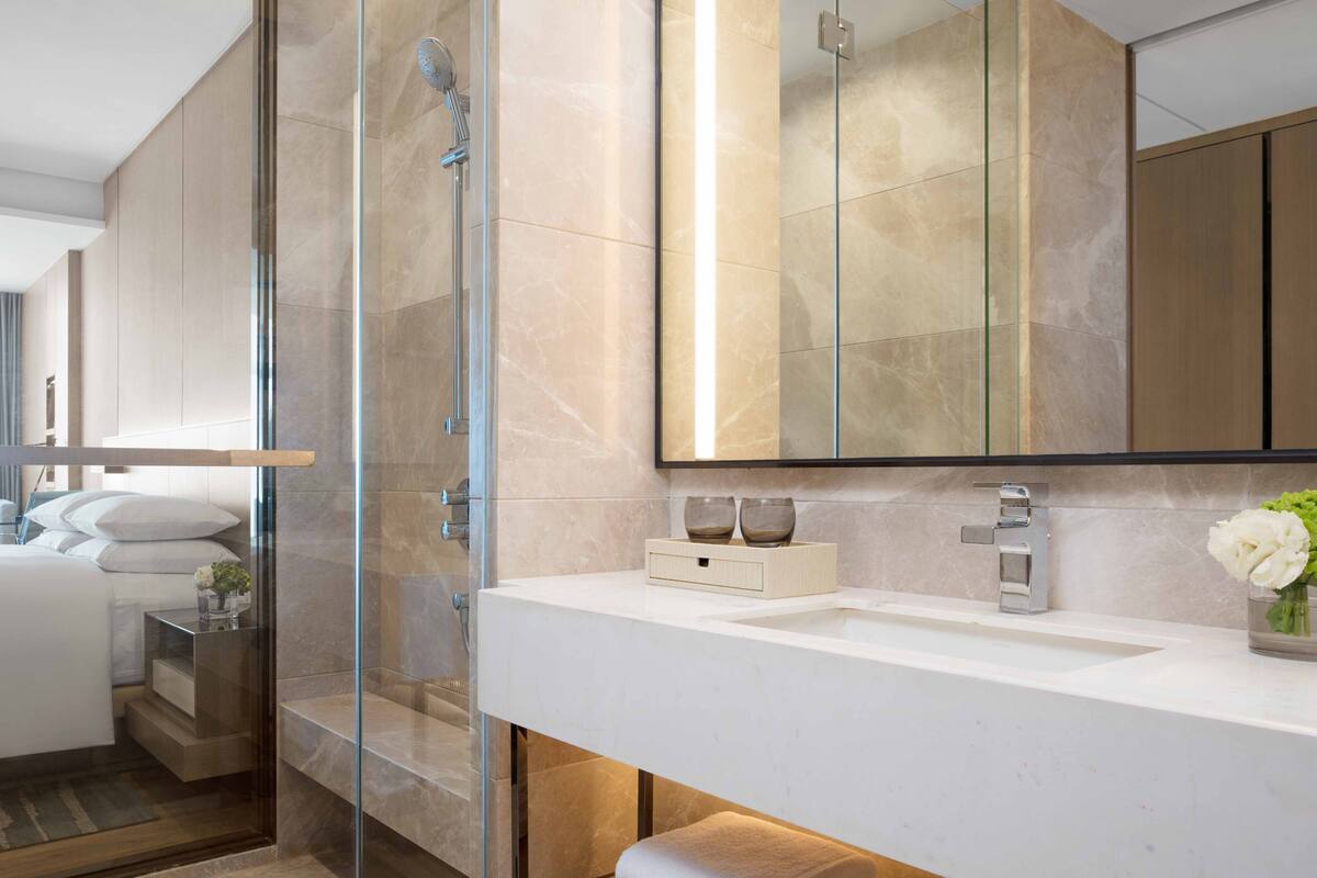 premier room, 1 king bed | bathroom | free toiletries, hair dryer, bathrobes, towels