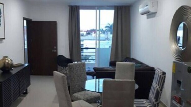 A modern living room with a pool table, two armchairs, a sofa, and a minibar. - Condo P (Mazatlán)