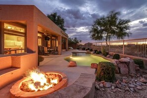 A modern outdoor pool area with a fire pit and seating. - Resort home On golf course, heated pool significant discount on monthly stays (Mesa)