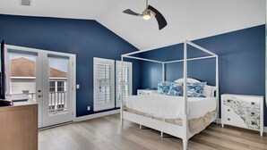 A bedroom with a four-poster bed, a ceiling fan, a nightstand, and a dresser. - Award-Winning Resort Amenities | Grand Pavilion 31 by Wild Dunes (Isle of Palms)