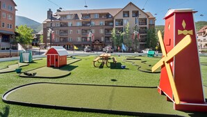 A hotel with multiple floors, outdoor seating, and a car wash facility.
