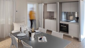 A modern kitchen with white cabinets, a stainless steel sink, and a built-in oven. - Palazzo Vendramin-Costa  Artist Studio-Loft (Venice)