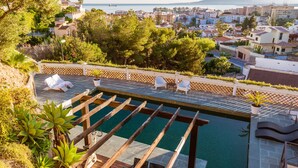 A rooftop pool with lounge chairs and a view of a coastal town. - Luxury Mediterranean Villa, High Standing , Sea Views (Málaga)