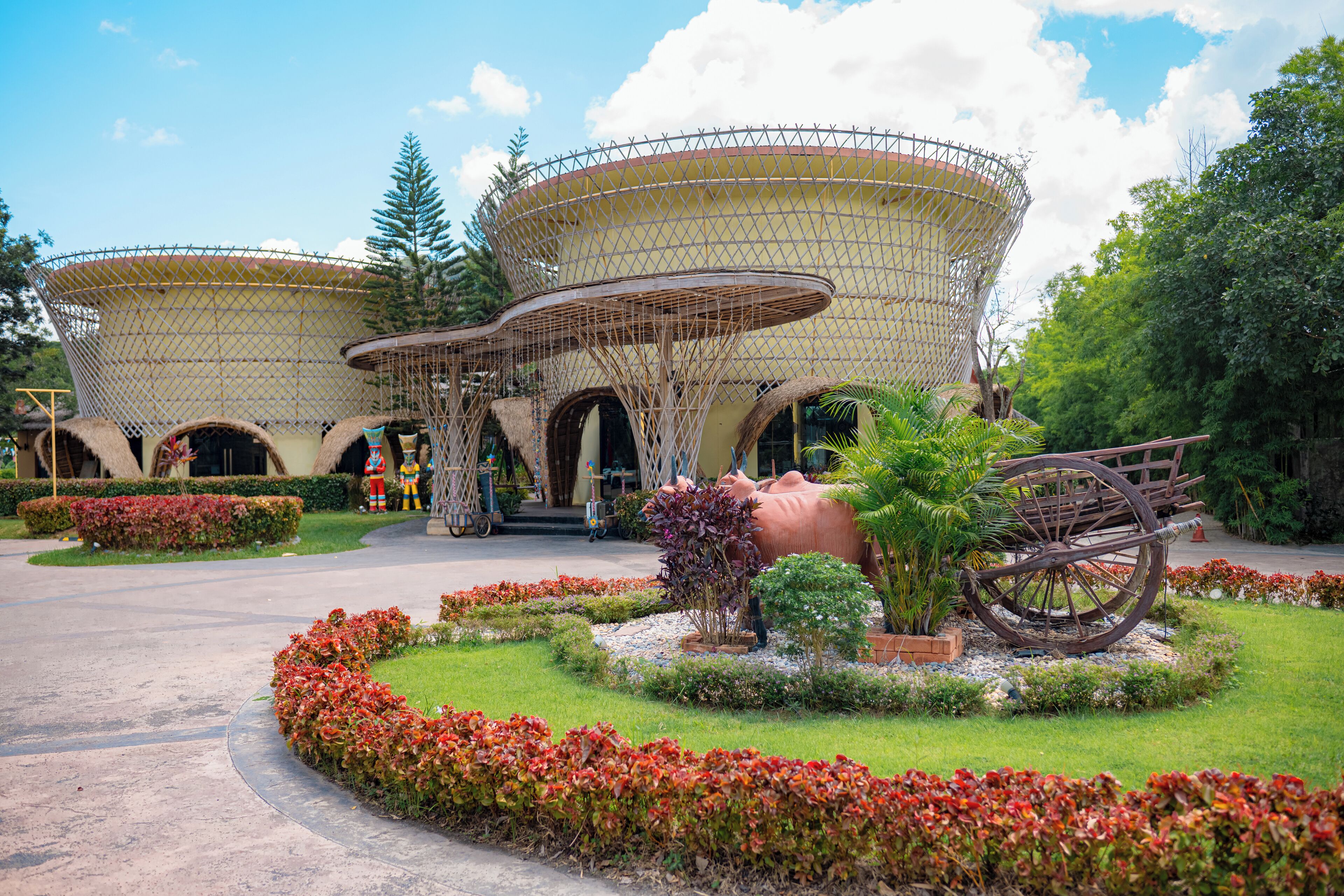 A building with a unique architectural design featuring large, rounded structures with a mesh-like exterior.