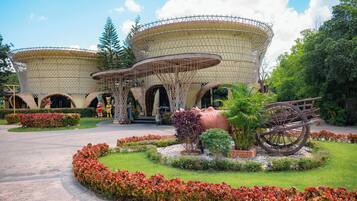 A building with a unique architectural design featuring large, rounded structures with a mesh-like exterior.