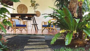 A stone staircase leading to a wooden deck with outdoor furniture. - The Snug Airportel (Sa Khu)