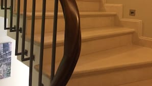 A staircase with a dark wooden handrail and white steps. - Leader Mansion Hotel & Suite (Istanbul)