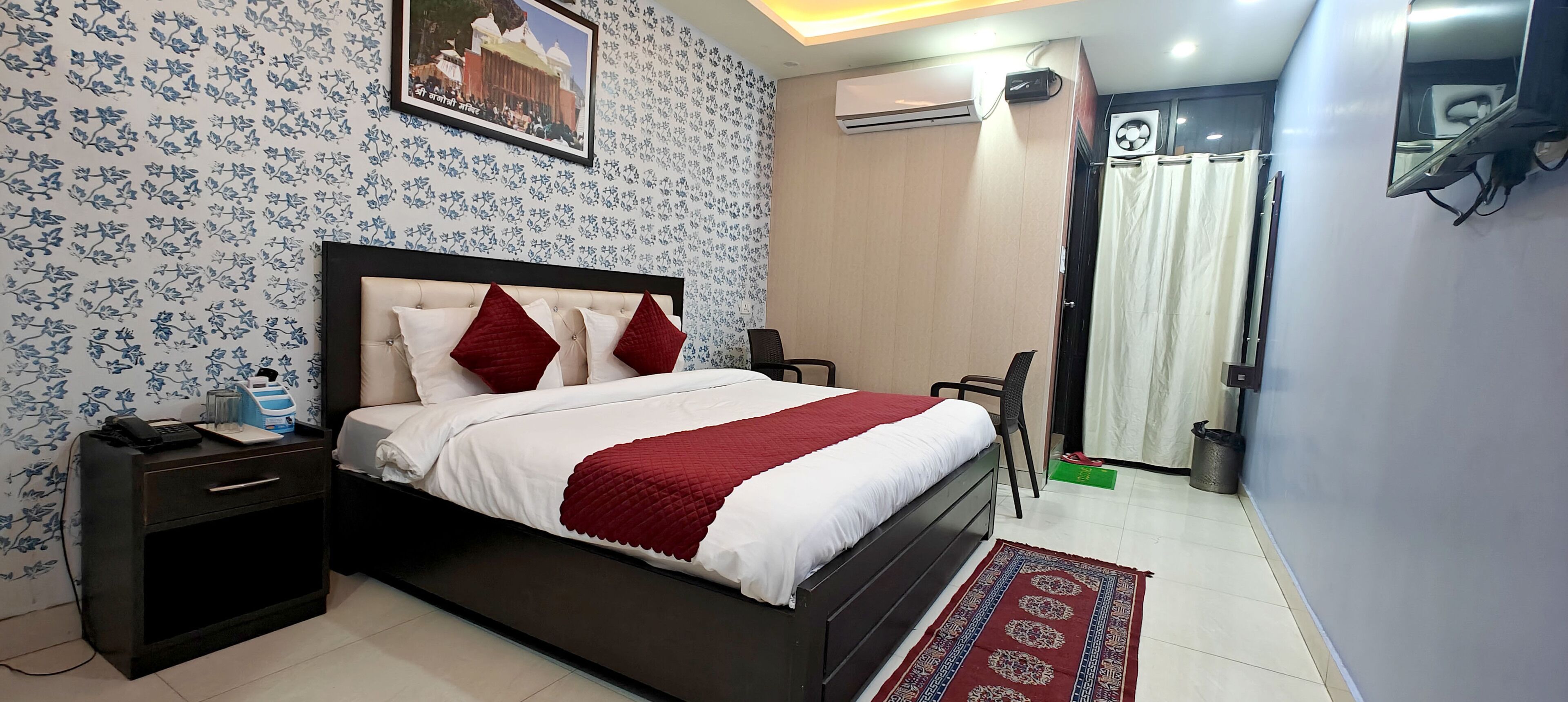 A neatly arranged bedroom with a bed, bedside table, and a chair.