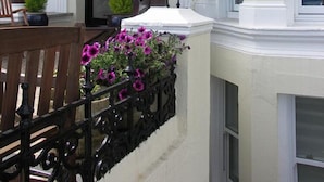 A building with the name 'inglewood' above the entrance. There is a bench and a planter with flowers in front of the entrance. - Opul Express (Douglas)