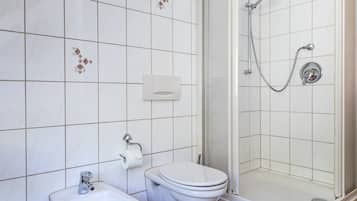 A bathroom with a sink, toilet, and shower.