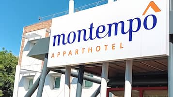 Un letrero para Montempo Apparthotel con diseño moderno y letras claras.