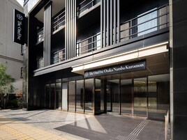 A modern building with a sign reading "The OneFive Osaka Namba Kuromon".