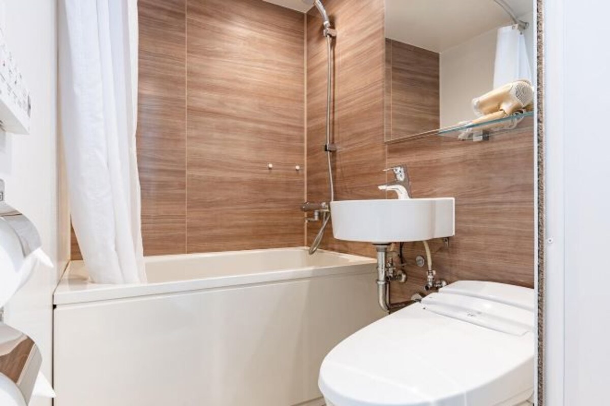 A modern bathroom with a bathtub, a sink, and a shower.