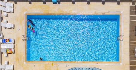 Seasonal outdoor pool, open 9:00 AM to 9:00 PM, free cabanas