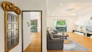 A modern living room with a sofa set, a coffee table, and a TV. - Happy Family Villa 2  (Chalong)