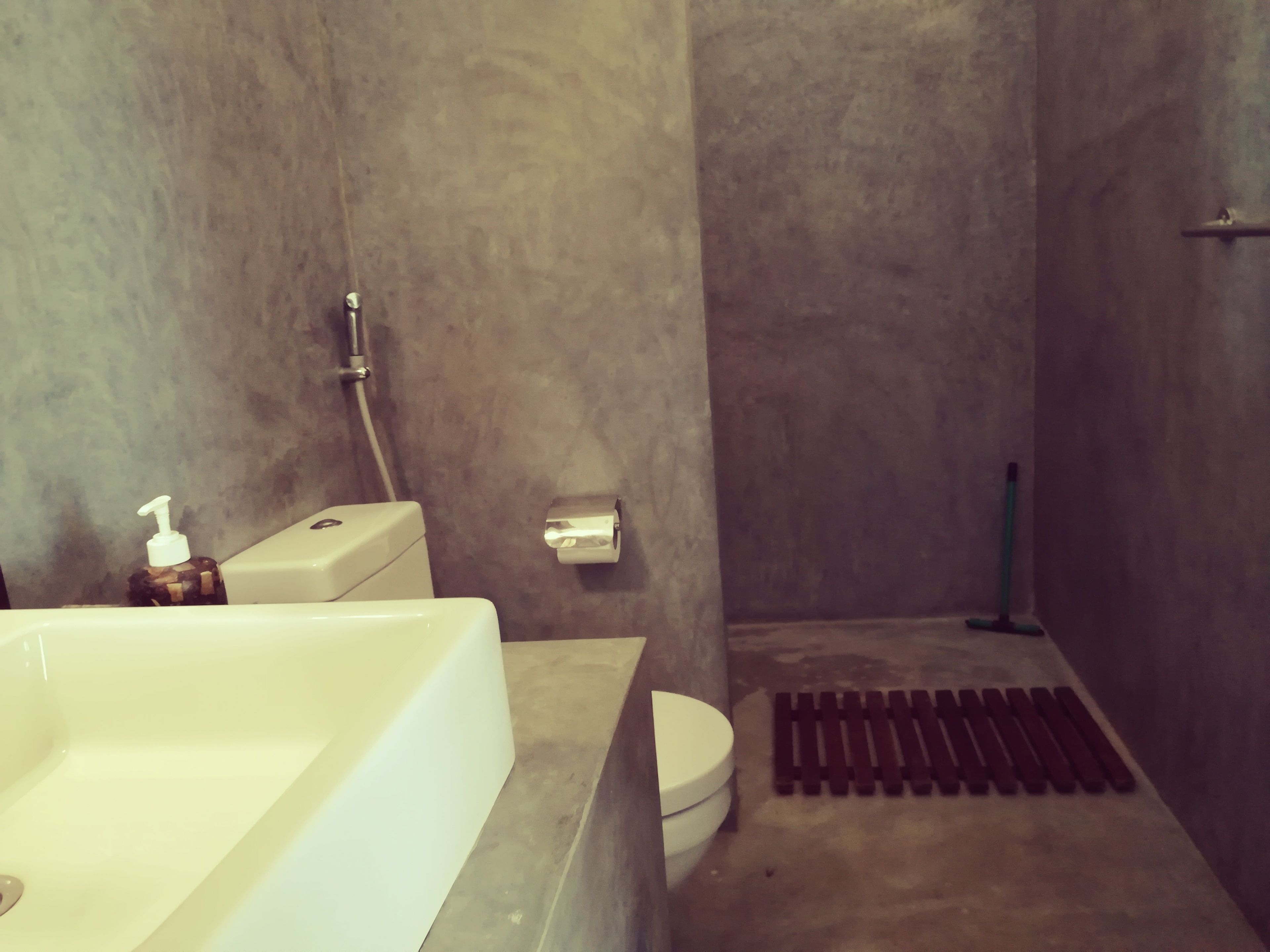 A bathroom with a bathtub, toilet, and shower area.