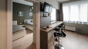 Eine moderne Wohnung mit Küchenzeile, Essbereich und Schlafzimmer.