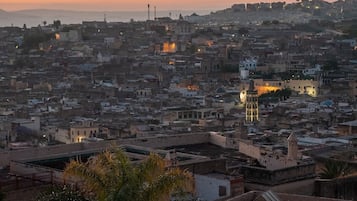 A densely packed urban area with a prominent tower and a mosque with a minaret, surrounded by residential buildings.