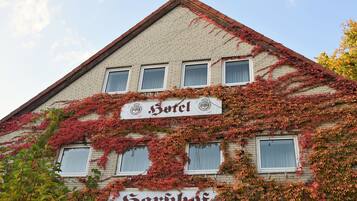 Hotel Sarbholz features a classic architectural style with a charming ivy-covered facade and red-tiled roof.