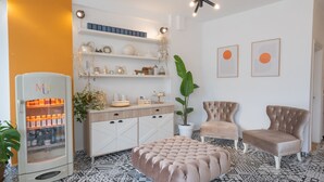 A modern living room with a patterned floor, a refrigerator, a potted plant, two upholstered chairs, and decorative wall art. - Muse No:1 (Marmaris)