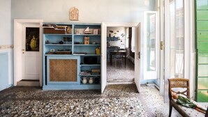 A room with a blue bookshelf, a wooden ceiling, and a tiled floor. - Venice Giardini Biennale Apartment (Venice)