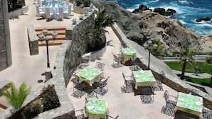 A seaside patio with tables and chairs, overlooking the ocean. - Hacienda Residences, Private 3-bedroom Villa (Cabo San Lucas)
