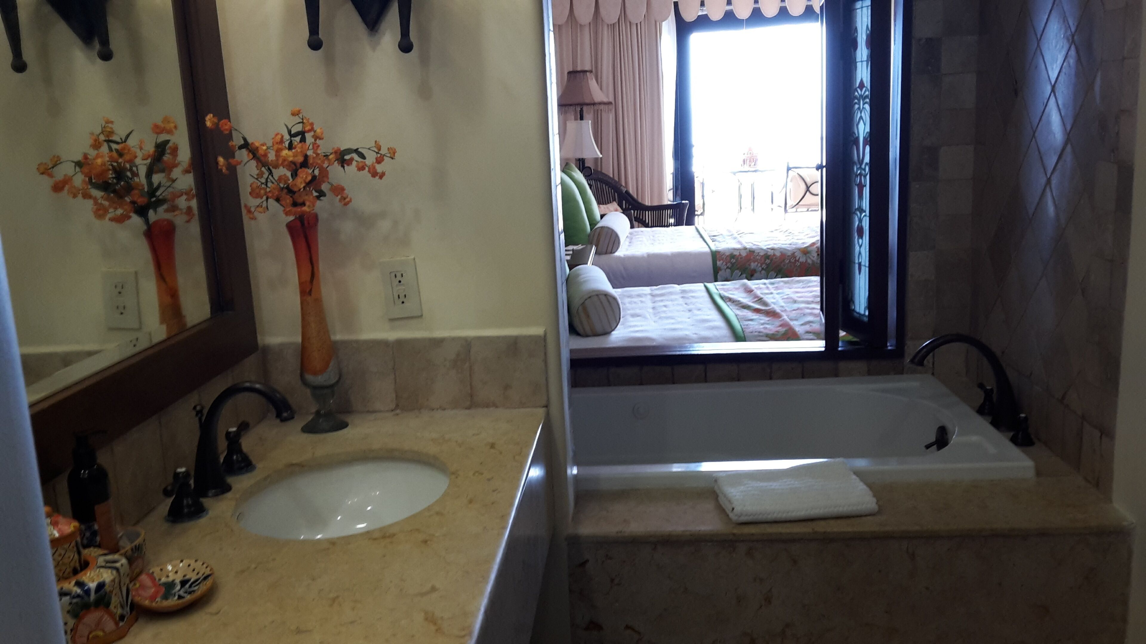 Une salle de bain avec un lavabo, un miroir et une baignoire.