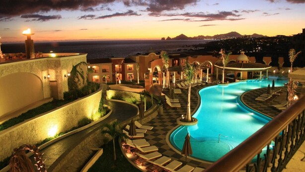 A resort pool area with a view of the ocean at sunset. - Rated for the Best Value in Cabo San Lucas!! 2BR 8P (Cabo San Lucas)