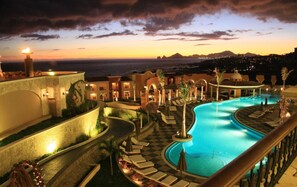 A resort pool area with a view of the ocean at sunset. - Rated for the Best Value in Cabo San Lucas!! 2BR 8P (Cabo San Lucas)