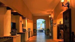 A corridor with a view of a fountain and palm trees, leading to a door. - Huge 3BR Private Villa - Cabo San Lucas (Cabo San Lucas)