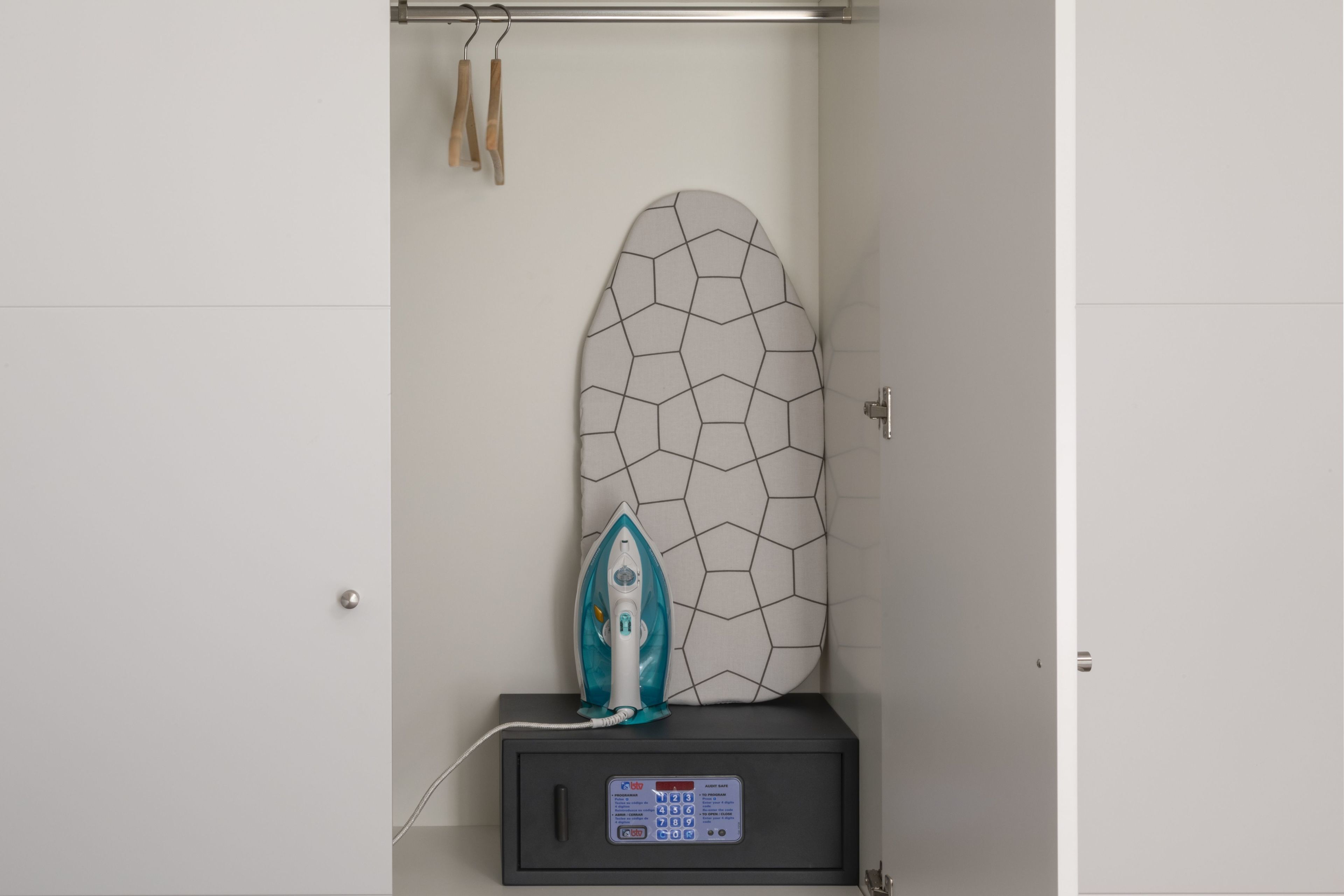 A bathroom with a towel rack, a towel, and a shower curtain.