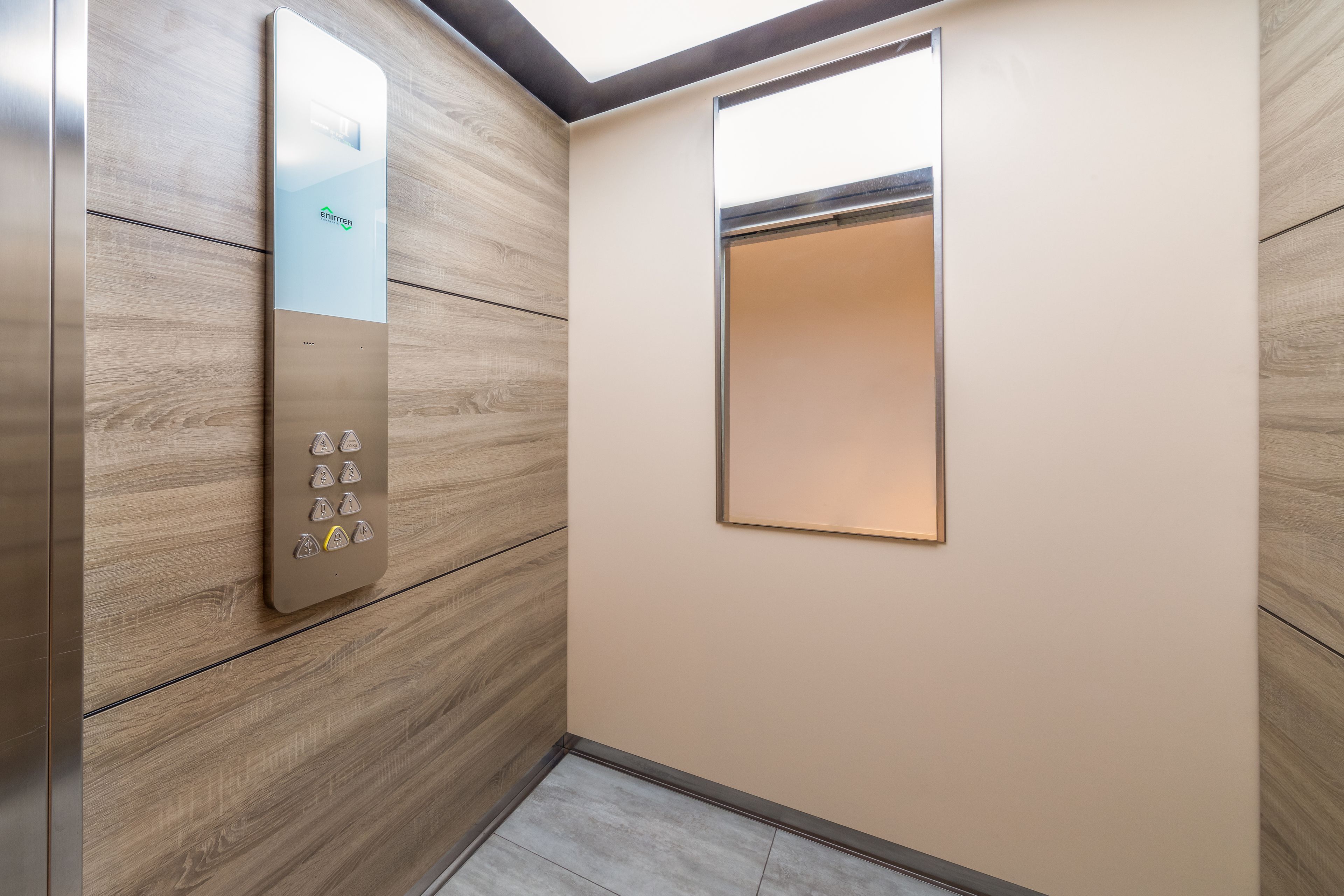 An elevator with a control panel and a small window.